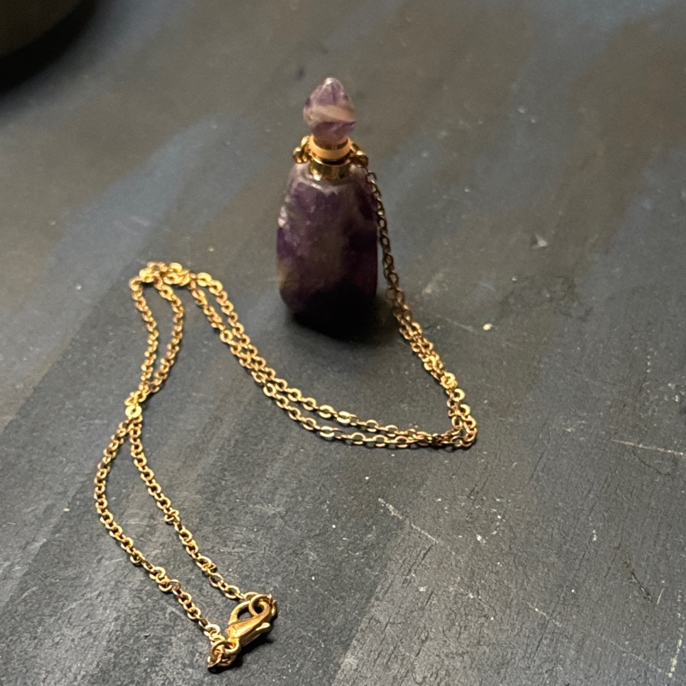 A Raw Amethyst Crystal Quartz Perfume Bottle Pendant with a Gold-Tone Chain